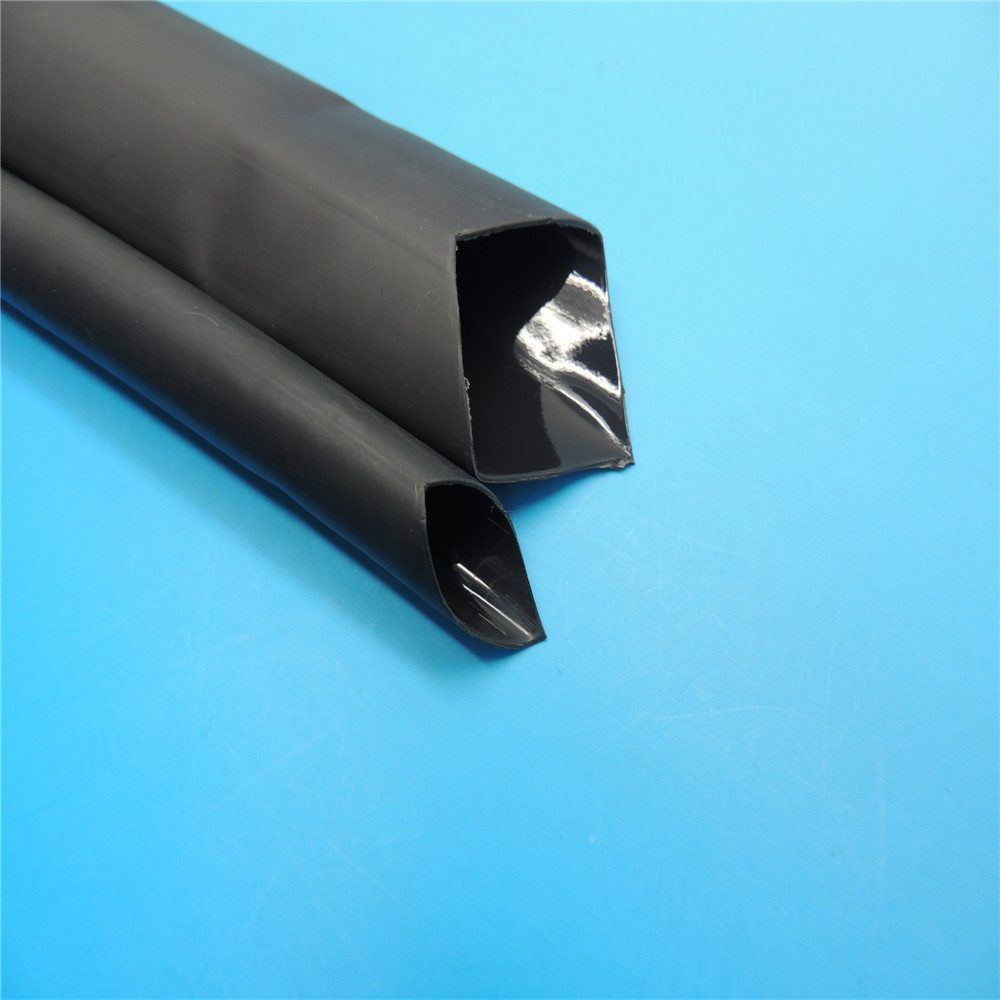 Adhesive-lined dual wall heat shrink sealing a cable splice